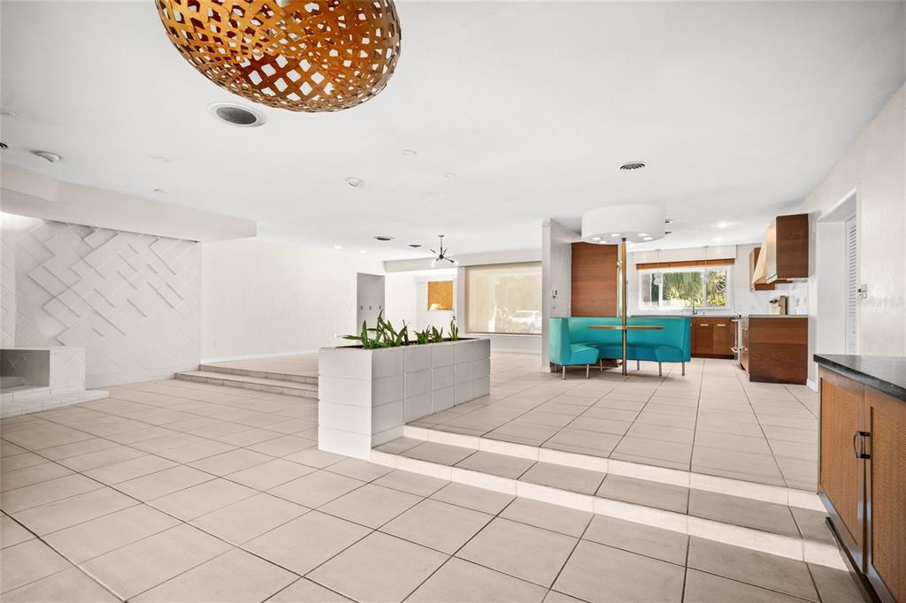 A spacious living area features a sunken floor, a tiered planter, and a turquoise booth — 801 PINELLAS POINT DRIVE S, ST PETERSBURG, FL