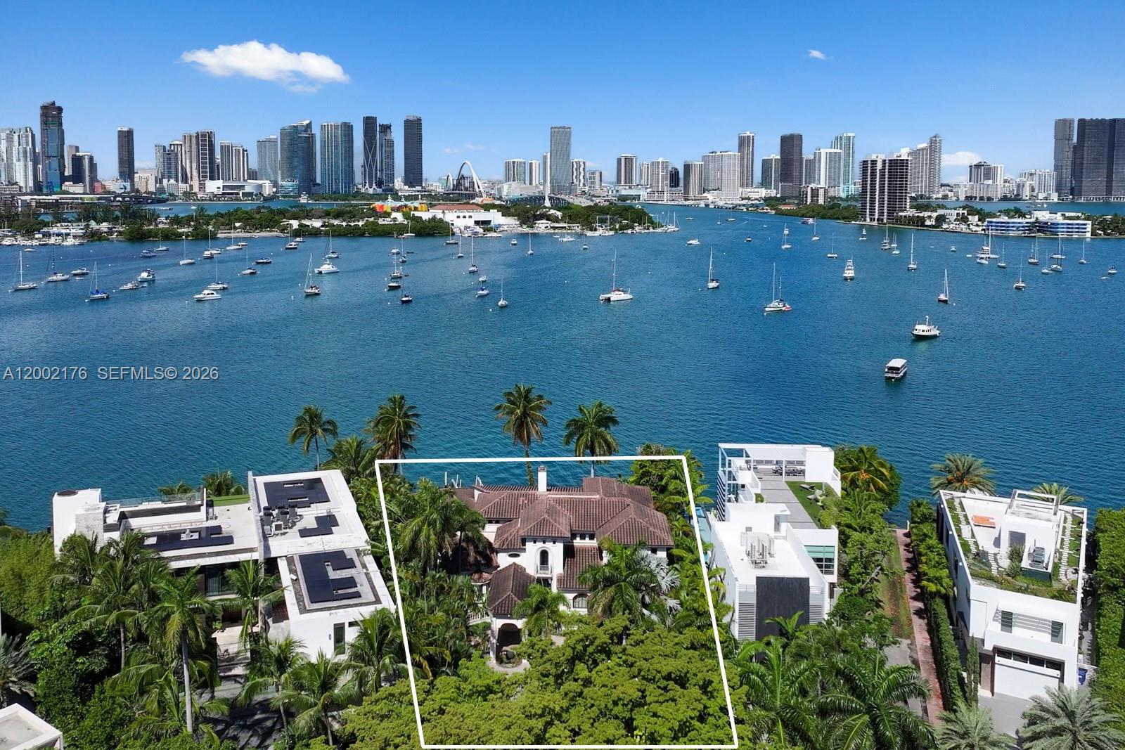 An aerial view shows a house with a tiled roof surrounded by lush tropical trees — 432 S Hibiscus Dr, Miami Beach FL 33139, MIAMI BEACH, FL