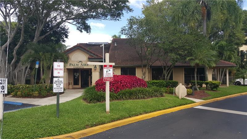 The exterior of a single-story building with a brown tiled roof and landscaped garden — 4541 W Mcnab Road # 26, Pompano Beach FL 33069, POMPANO BEACH, FL