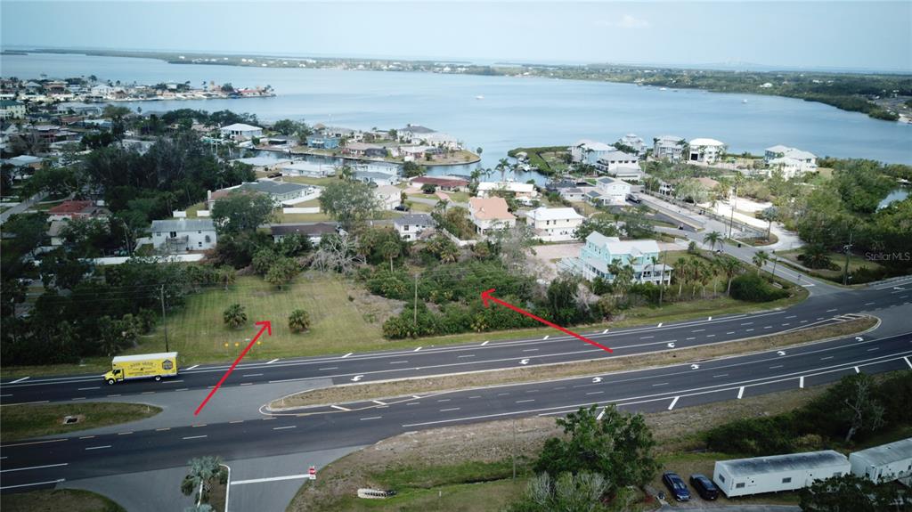 An aerial view shows a vacant lot situated next to a multi-lane highway and water — 5405 US HIGHWAY 19, PALMETTO, FL