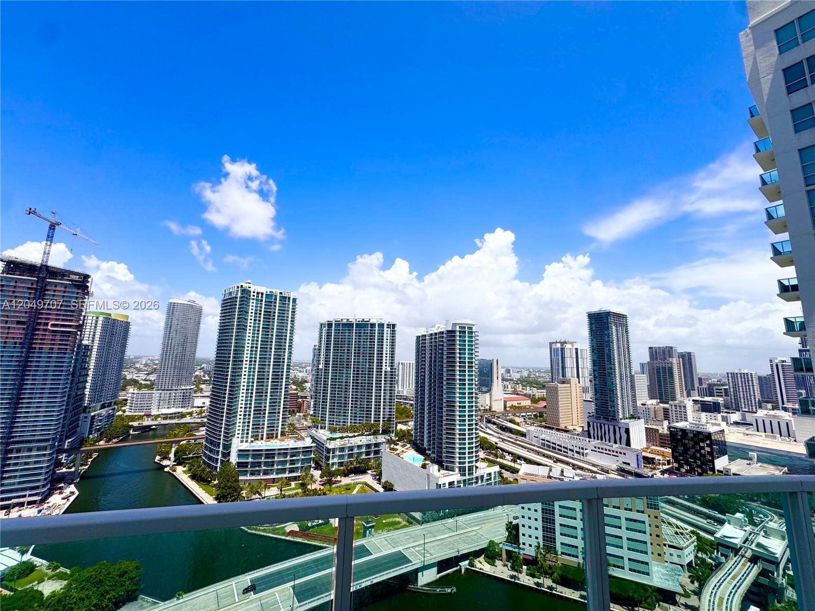 A high-angle view shows a city skyline with skyscrapers, a river, and a highway — 41 SE 5th St # 1917, Miami FL 33131, MIAMI, FL