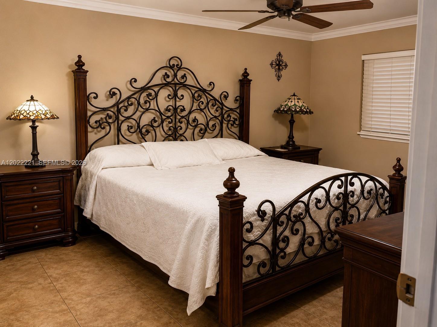 A bedroom features a wrought iron and wood bed frame, two stained-glass lamps, and tile flooring — 2839 Taylor St # 8, Hollywood FL 33020, HOLLYWOOD, FL