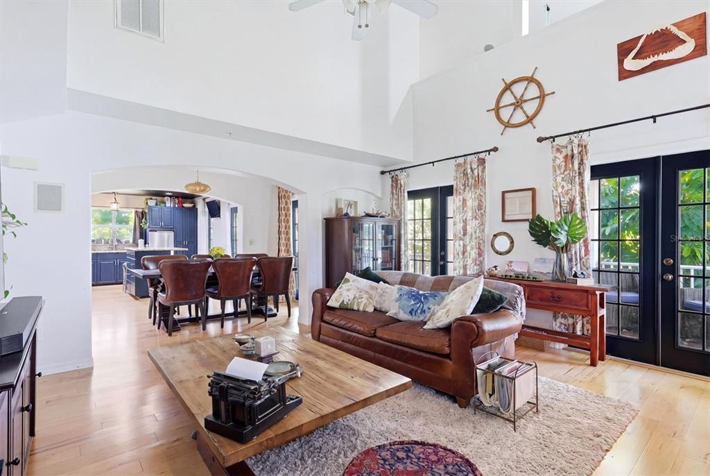 A three-story, light-colored house with a front porch, a garage, and a landscaped front yard — 7107 HAWKS HARBOR CIRCLE, BRADENTON, FL