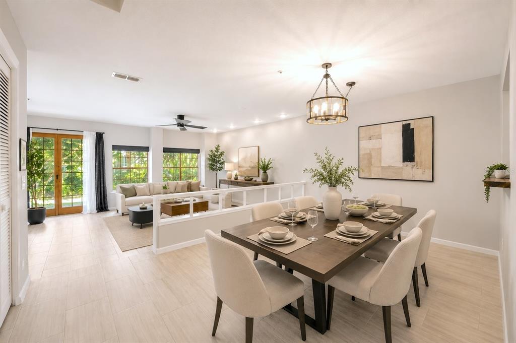A dining area with a wooden table leads into a sunken living room with tile floors — 641 MAPLE OAK CIRCLE UNIT 101, ALTAMONTE SPRINGS, FL