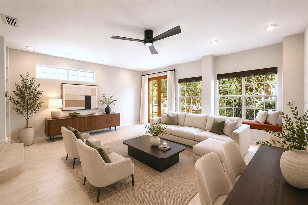 A bright living room features a sectional sofa, two armchairs, a coffee table, and large windows — 641 MAPLE OAK CIRCLE UNIT 101, ALTAMONTE SPRINGS, FL