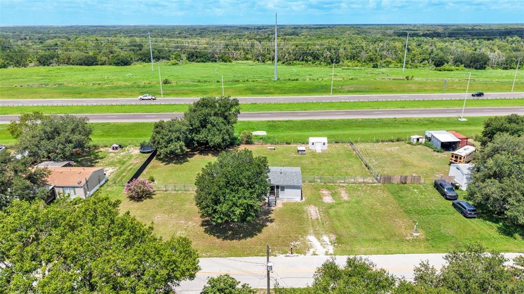An aerial view shows a house on a large lot next to a highway — 1329 ASHLEE COURT, AUBURNDALE, FL