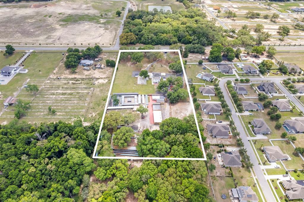An aerial view shows a large, rectangular property lot containing several buildings and mature trees — 2509 APPY LANE, APOPKA, FL