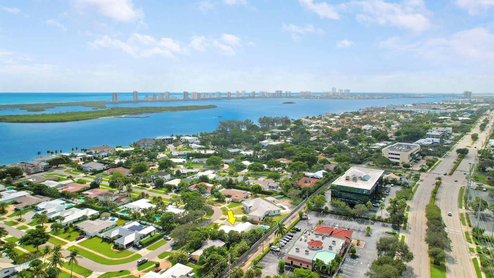 An aerial view shows a residential neighborhood near a bay with a yellow arrow pointing down — 731 Cruiser Road S, North Palm Beach FL 33408, NORTH PALM BEACH, FL