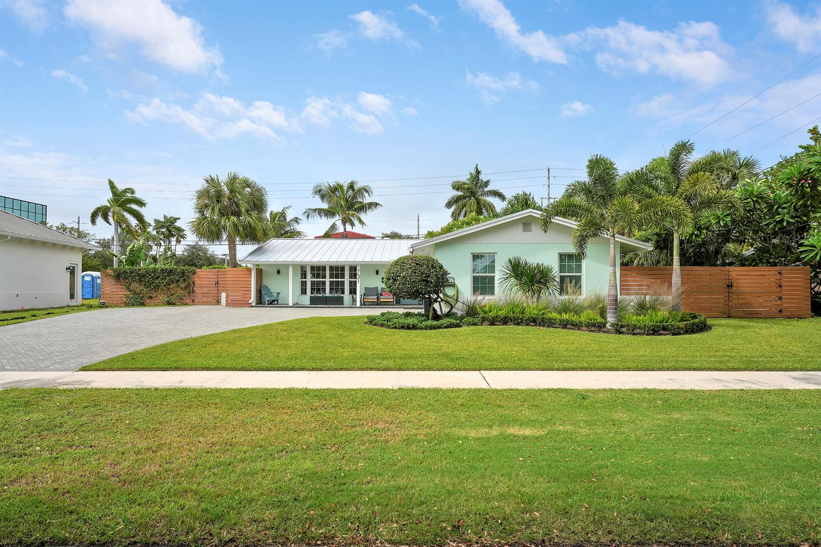A light green single-story house with a metal roof and a large front lawn — 731 Cruiser Road S, North Palm Beach FL 33408, NORTH PALM BEACH, FL