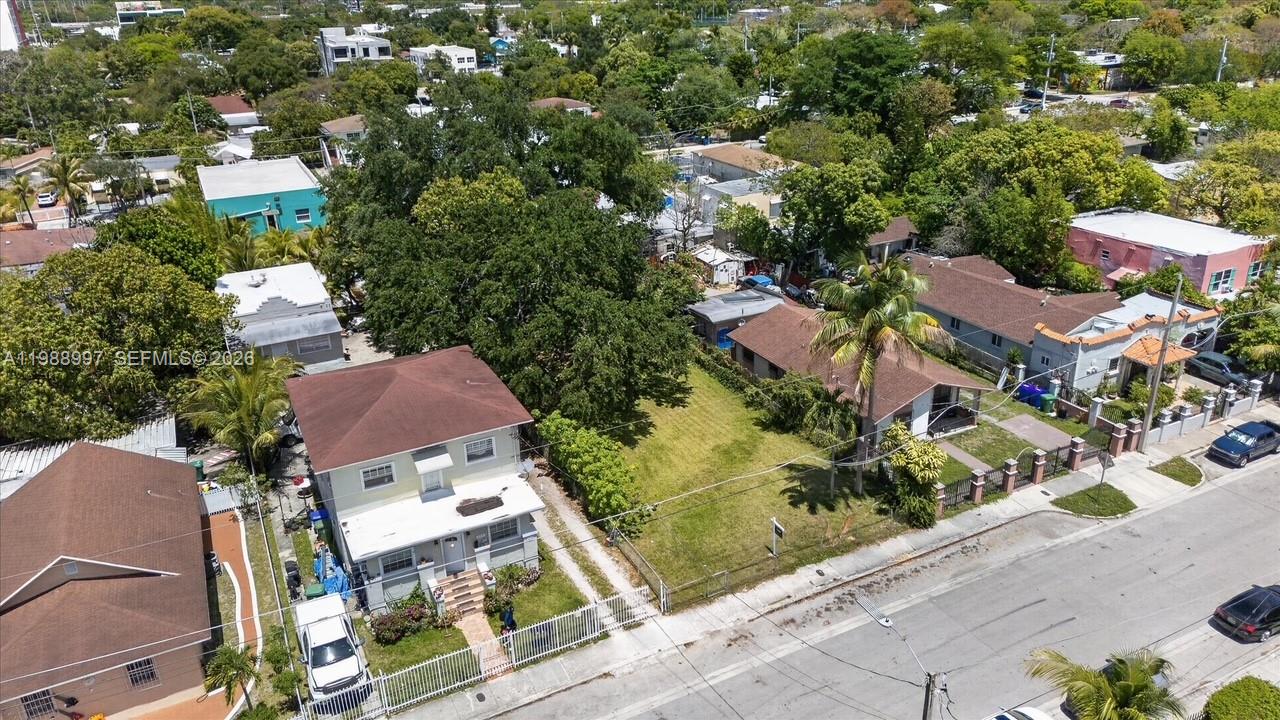 An aerial view shows two houses separated by a vacant lot in a residential neighborhood — 267 NW 31st St, Miami FL 33127, MIAMI, FL