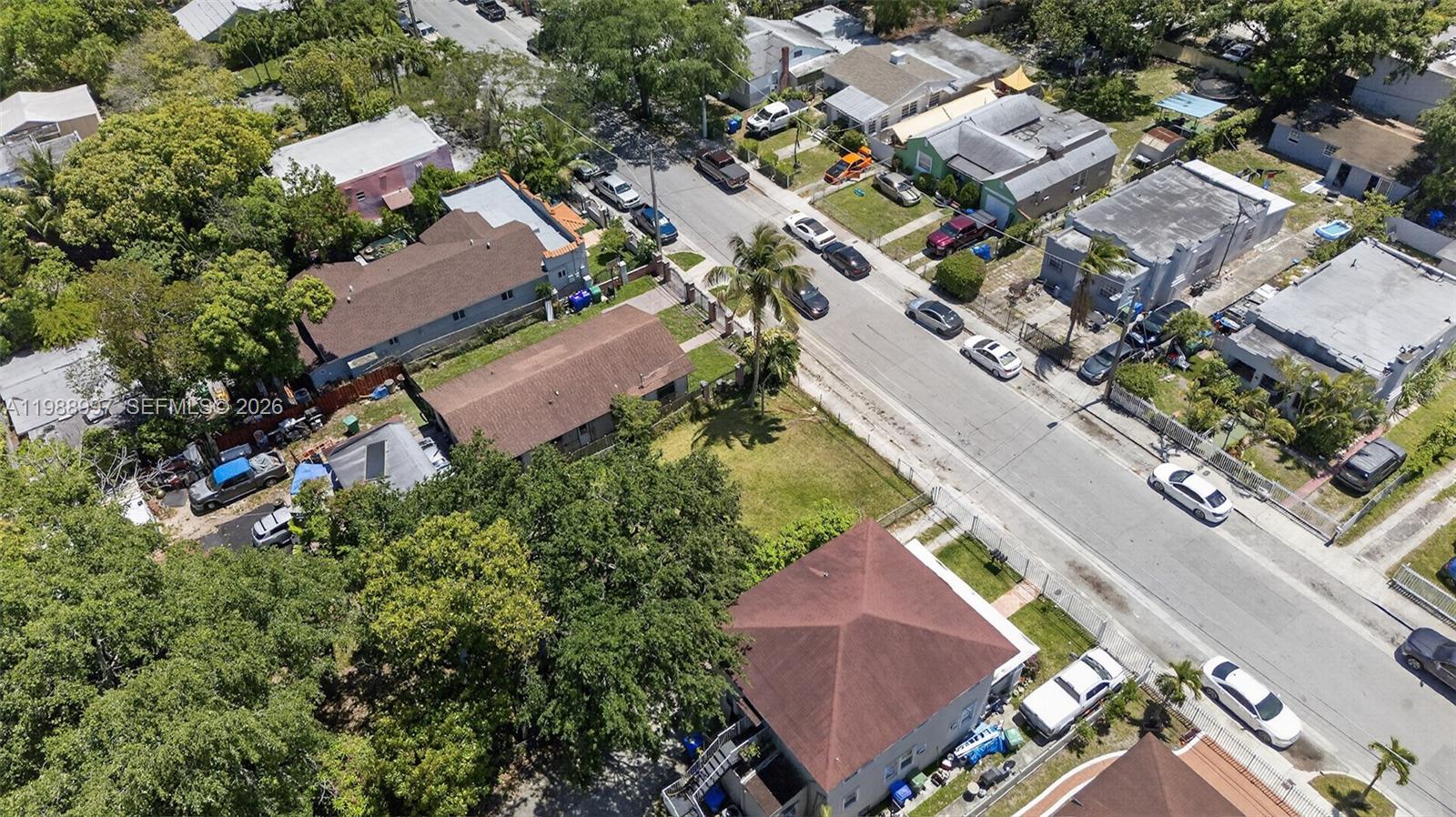 An aerial view shows a residential street lined with houses, trees, and parked cars — 267 NW 31st St, Miami FL 33127, MIAMI, FL
