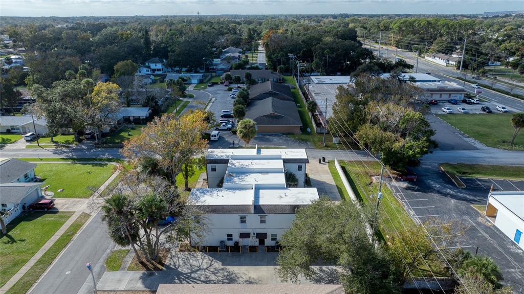 An aerial view shows a multi-unit residential building with a flat roof and parking lot — 644 NORTHERN ROAD, SOUTH DAYTONA, FL