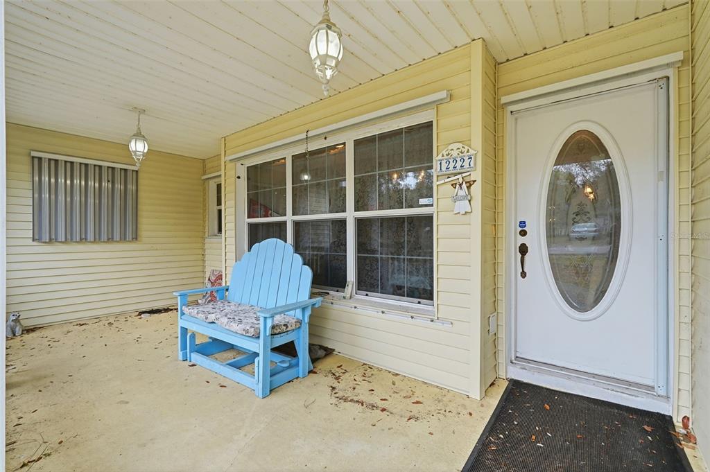 A single-story house with yellow siding, a white fence, and a two-car garage — 12227 TERRA CEIA AVENUE, NEW PORT RICHEY, FL