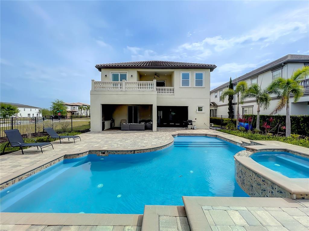 A two-story house exterior features a swimming pool, a hot tub, and a covered patio — 760 GOLDEN BEAR DRIVE, REUNION, FL