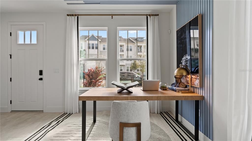 A home office features a wooden desk, a gray chair, and blue vertical wall paneling — 15075 GROVESIDE ROAD, WINTER GARDEN, FL