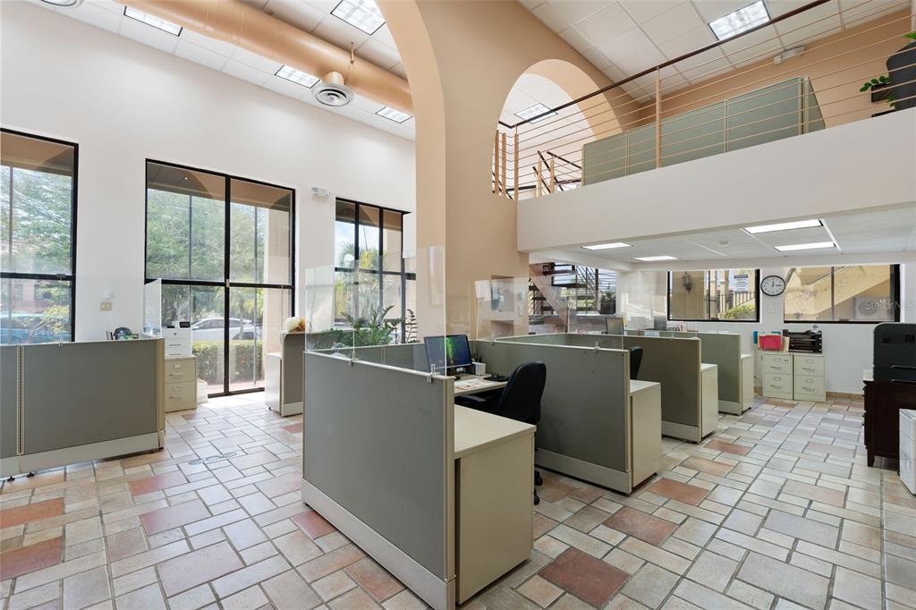 An office space features cubicles, tiled flooring, high ceilings, and an open mezzanine level — 295 PALMAS INN WAY UNIT C11, HUMACAO, PR