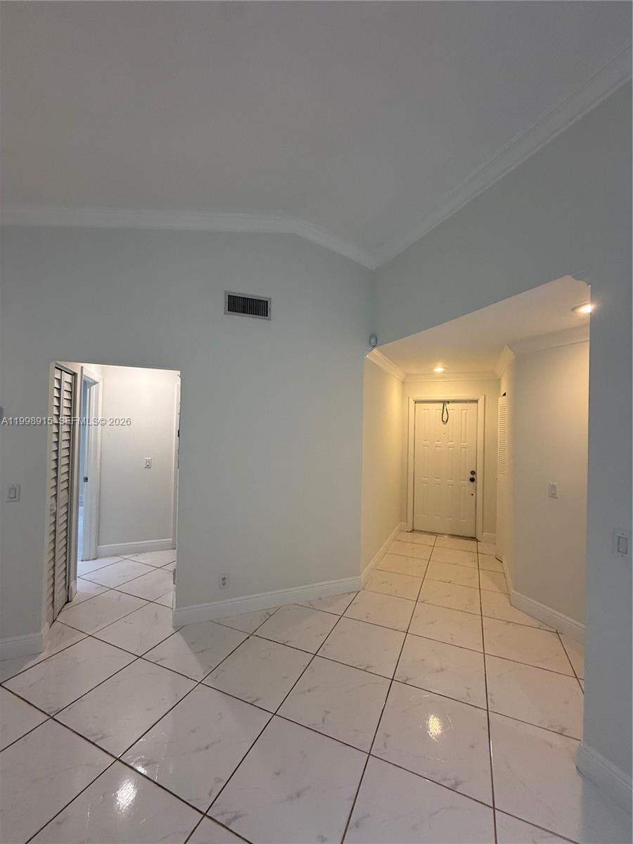 An interior view shows a tiled entryway leading to a front door and a hallway — 17268 NW 60th Ct, Hialeah FL 33015, HIALEAH, FL