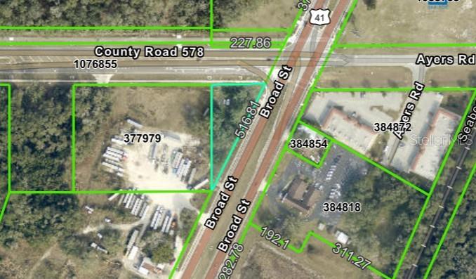 This is an aerial map showing property boundaries and parcel numbers near a road intersection — BROAD STREET, BROOKSVILLE, FL