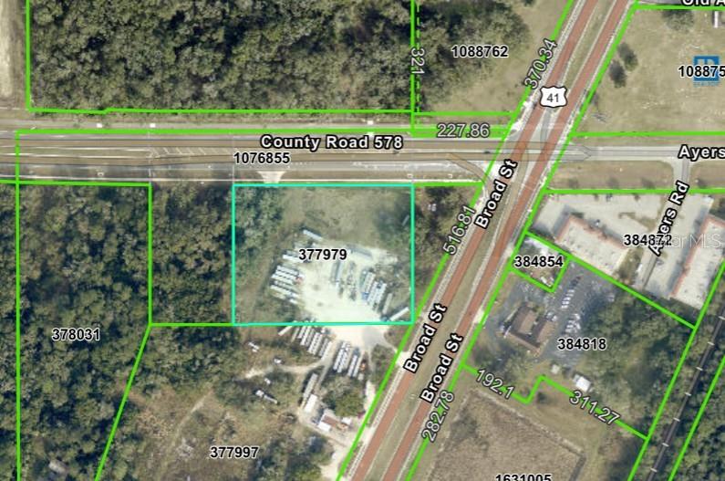 This is an aerial map showing property boundaries and parcel numbers near a highway intersection — BROAD STREET, BROOKSVILLE, FL