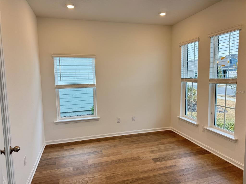 A white single-story house with a three-car garage and a prominent front entryway — 3581 ZYDECO LOOP, GREEN COVE SPRINGS, FL