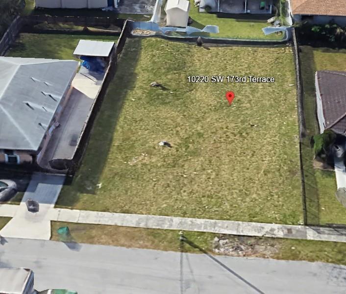 An aerial view shows a vacant, rectangular residential lot situated between two existing houses — 10220 SW 173rd Terrace, Miami FL 33157, MIAMI, FL