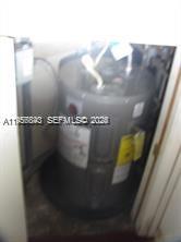 A water heater is installed inside a small utility closet — 900 NE 209th Ter # 31, Miami FL 33179, MIAMI, FL