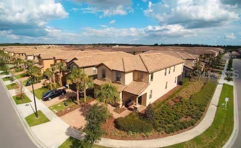 An aerial view shows a two-story suburban house with a tiled roof and palm trees — 8956 RHODES STREET, KISSIMMEE, FL