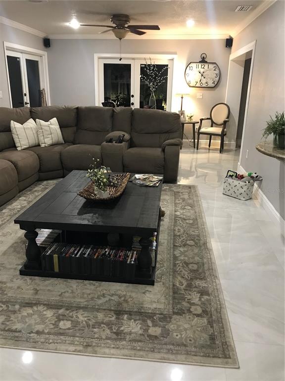 A living room features a large brown sectional sofa, a black coffee table, and tile flooring — 14821 PALMETTO PALM AVENUE, MIAMI LAKES, FL