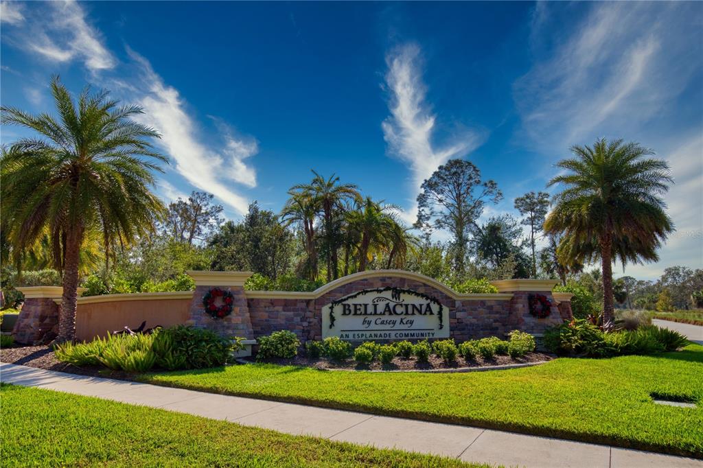 A stone community entrance sign for Bellacina by Casey Key sits amidst palm trees — 5628 SEMOLINO STREET, NOKOMIS, FL