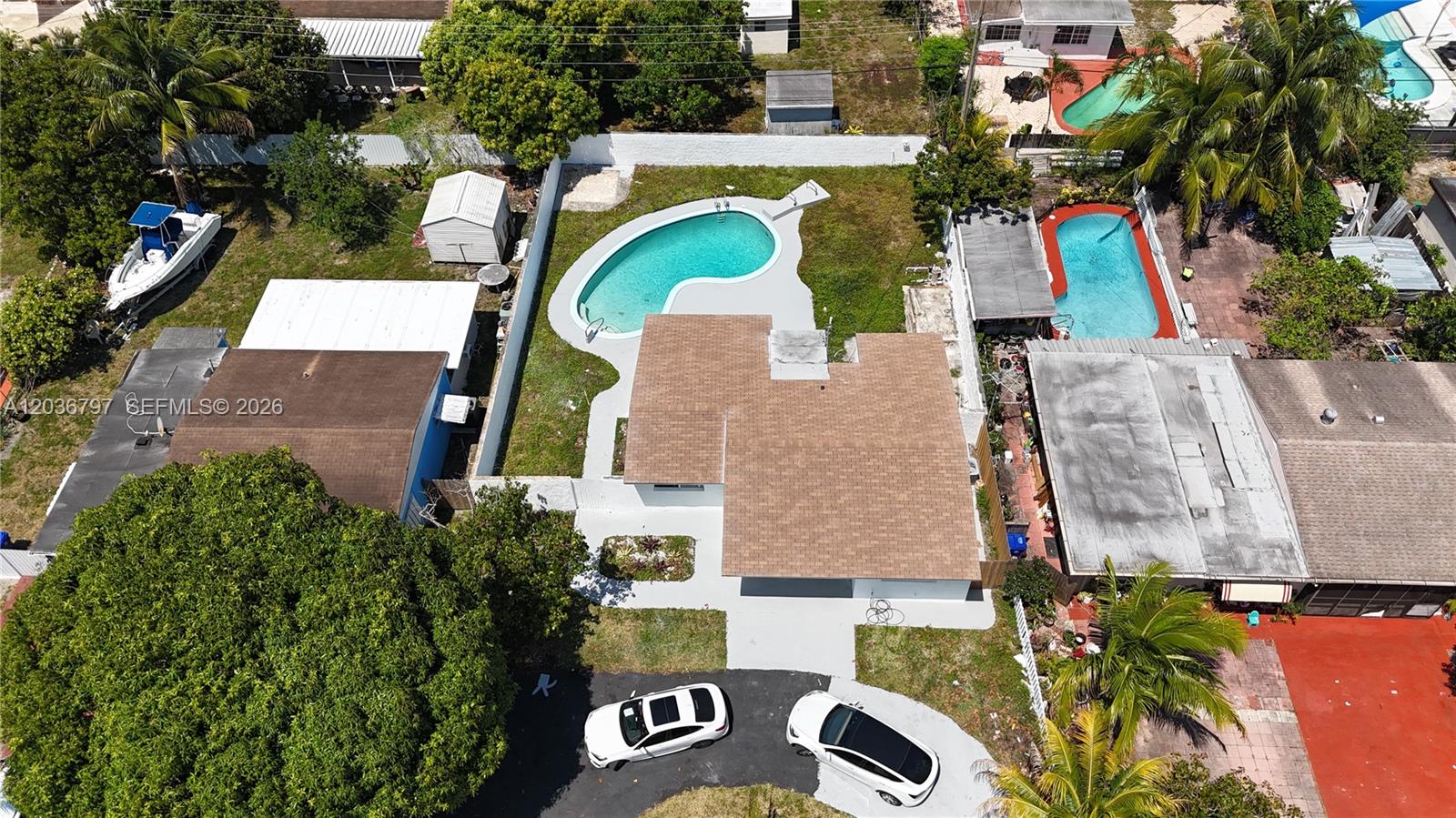 An aerial view shows a house with a pool, a driveway, and surrounding properties — 6515 SW 20th Ct, Miramar FL 33023, MIRAMAR, FL