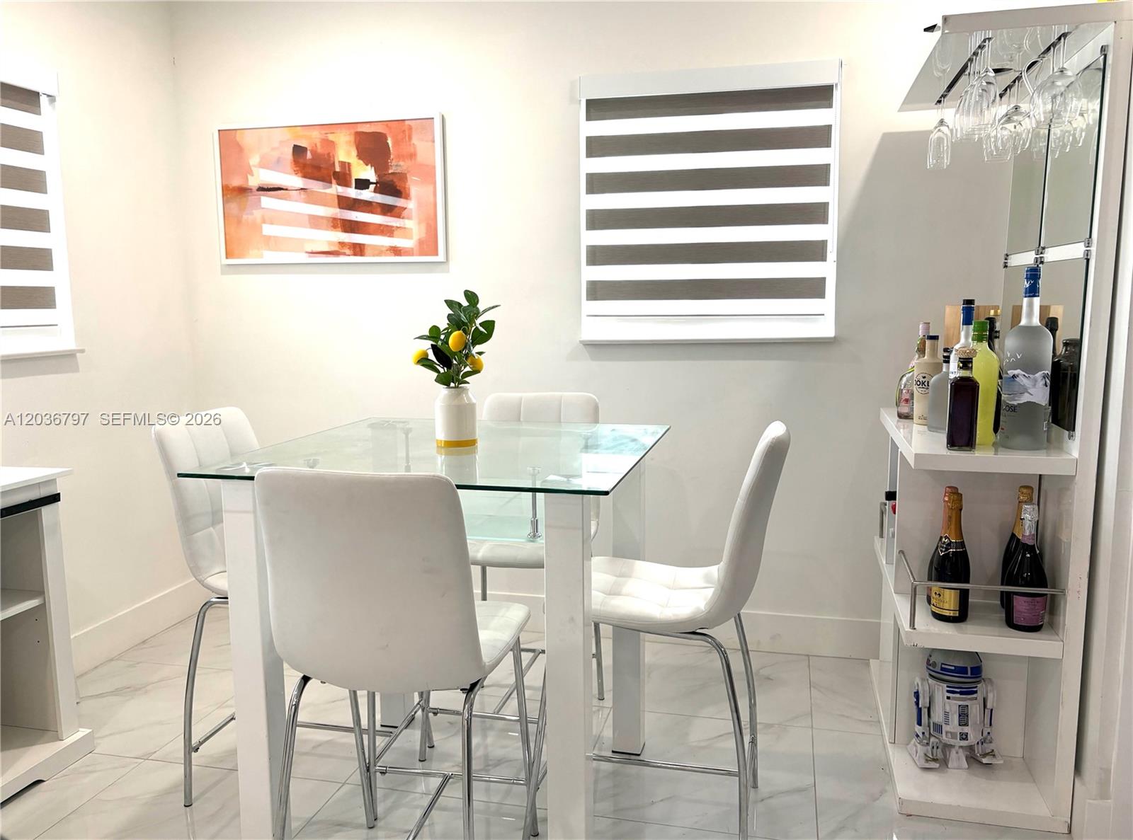 A dining area features a glass-topped table, four white chairs, and a built-in bar — 6515 SW 20th Ct, Miramar FL 33023, MIRAMAR, FL