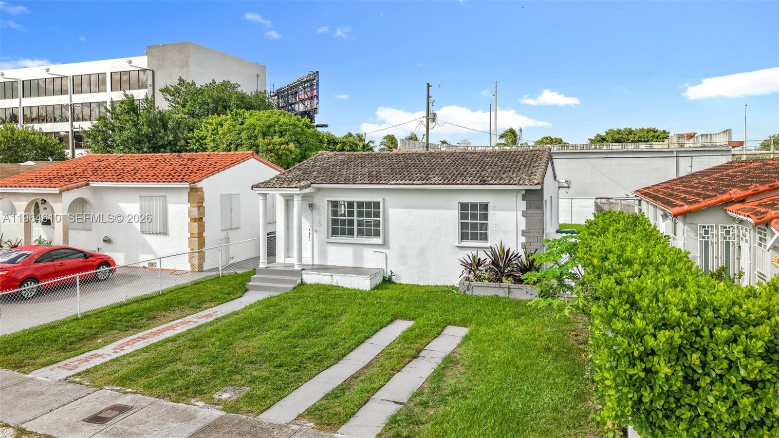 A white single-story house with a tiled roof sits behind a grassy front yard — 6819 SW 25th St, Miami FL 33155, MIAMI, FL