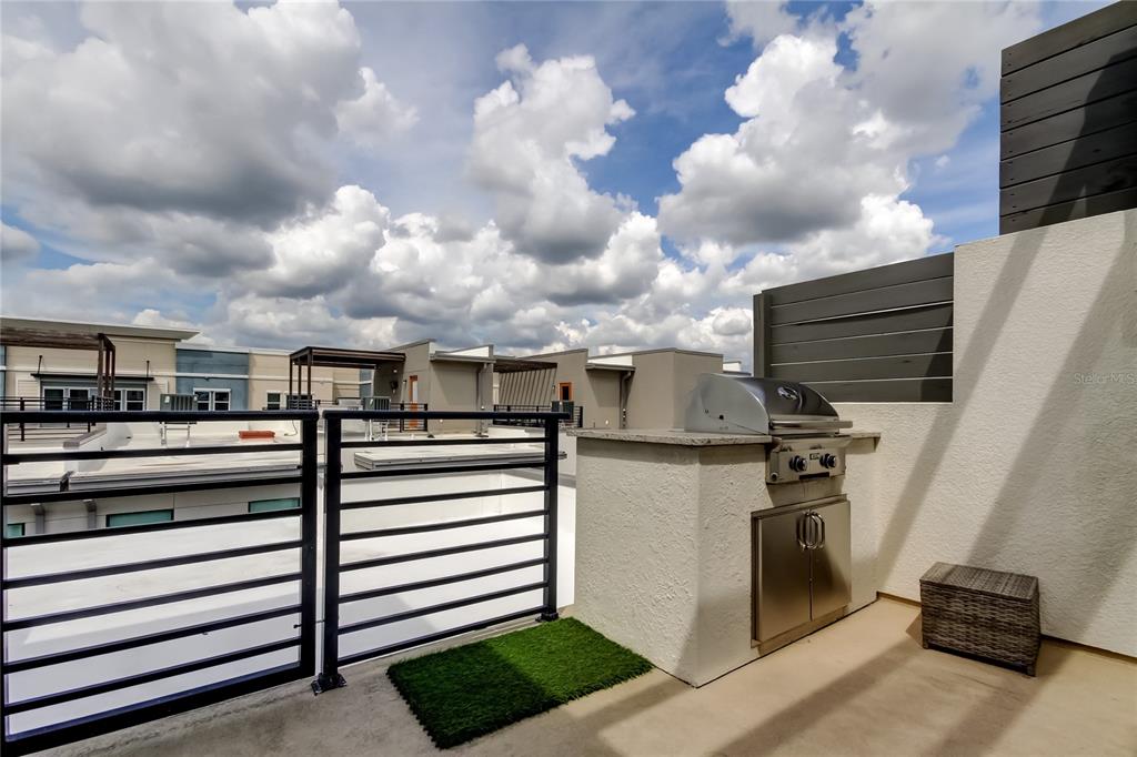 A rooftop terrace features a built-in grill station, metal railings, and a small patch of turf — 2511 N GRADY AVENUE UNIT 78, TAMPA, FL