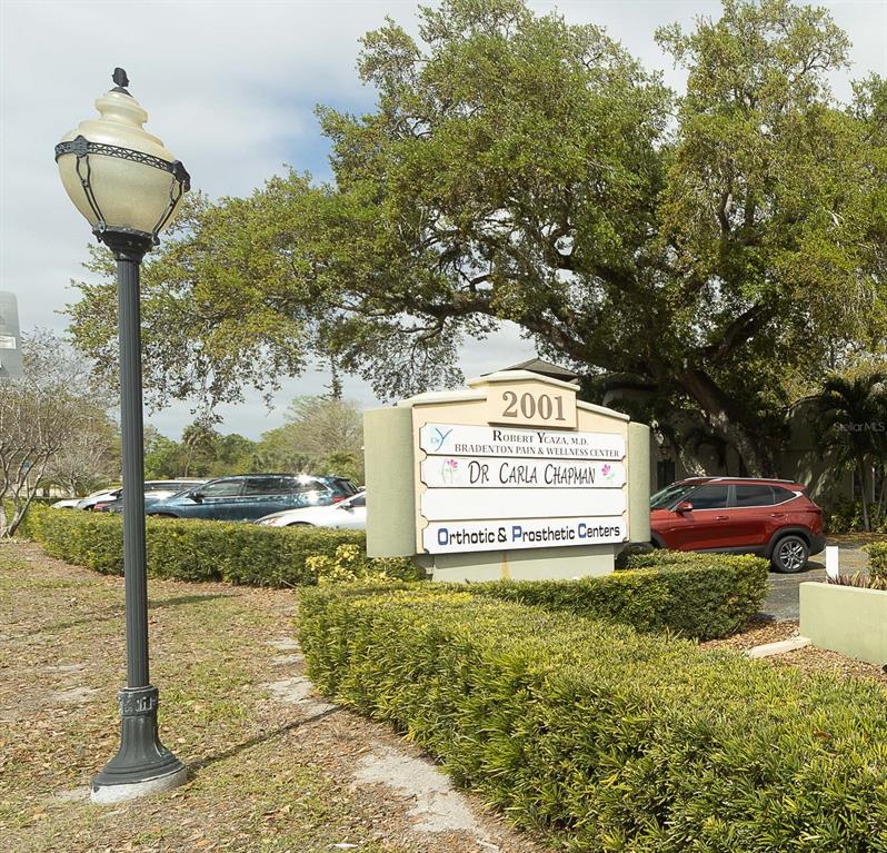 A sign for a medical office building stands in front of a parking lot — 2001 MANATEE AVENUE E UNIT 104, BRADENTON, FL