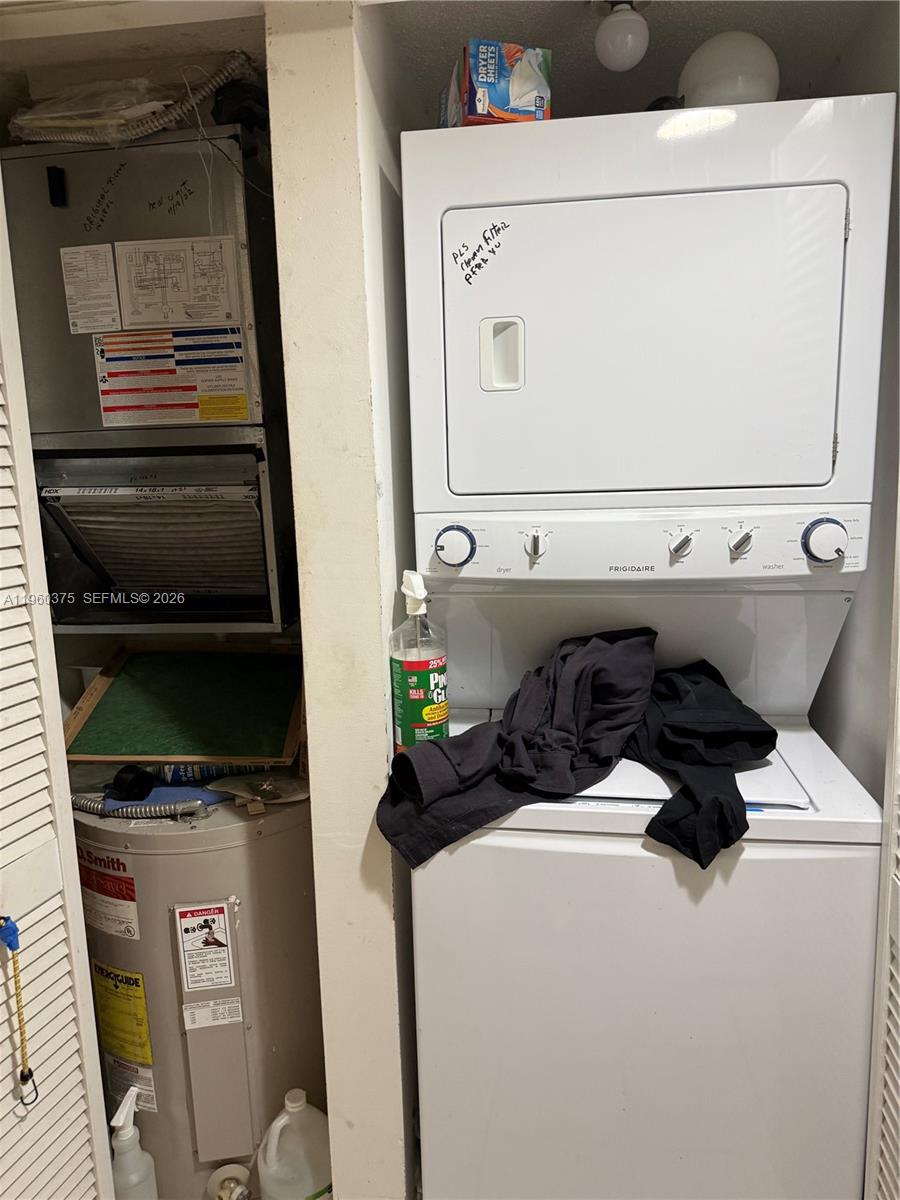 A utility closet contains a stacked washer-dryer unit, a water heater, and an HVAC system — 4677 NW 9th St # 106, Miami FL 33126, MIAMI, FL