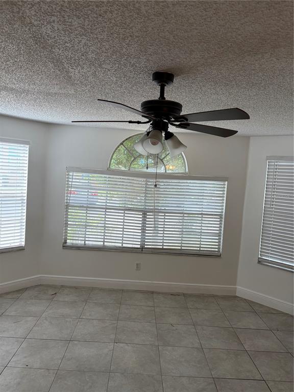 A room with tile flooring, a ceiling fan, and windows with blinds — 2717 N POINCIANA BOULEVARD UNIT 169, KISSIMMEE, FL