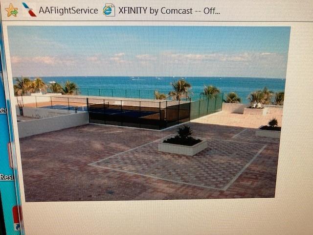A rooftop terrace features a tennis court, brick pavers, and a view of the ocean — 1370 S Ocean Boulevard # 1706, Pompano Beach FL 33062, POMPANO BEACH, FL