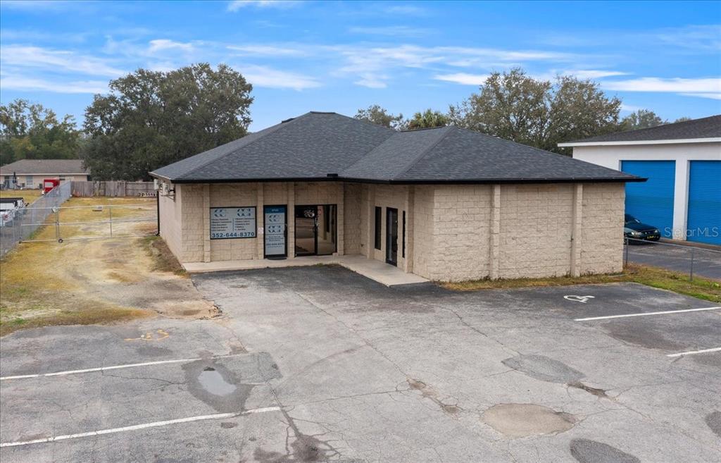 An exterior view of a single-story commercial building with a tan block facade — 2733 SE 58TH AVENUE, OCALA, FL