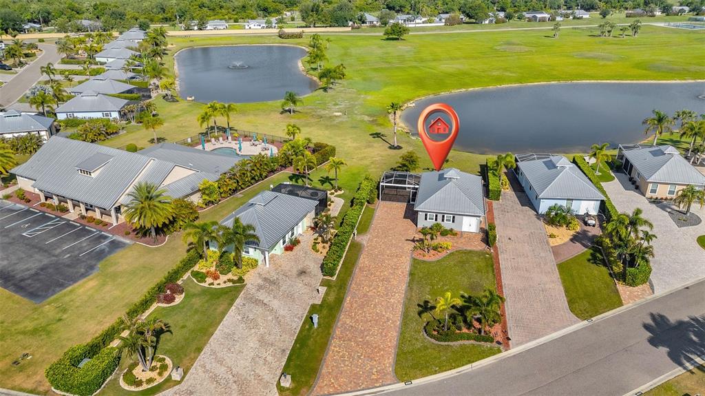 An aerial view shows a residential house with a red location pin near a lake — 8306 SW SAND CRANE LOT 87 CIRCLE, ARCADIA, FL