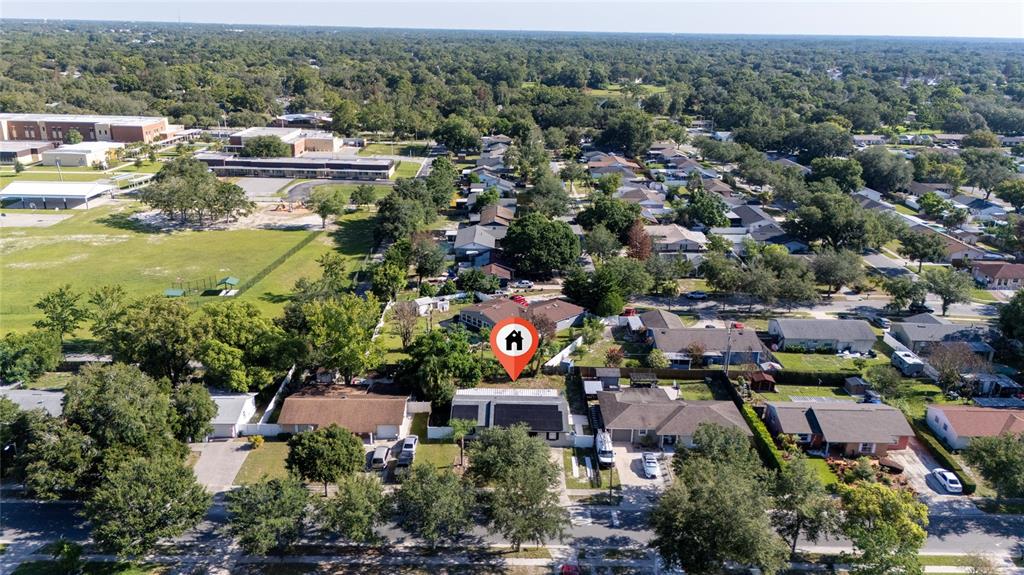 An aerial view shows a residential neighborhood with a house highlighted by a red icon — 618 JUPITER WAY, CASSELBERRY, FL