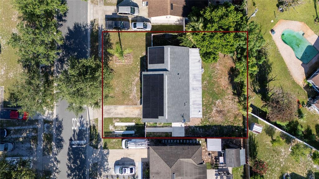 Aerial view of a house with solar panels on the roof and a large yard — 618 JUPITER WAY, CASSELBERRY, FL