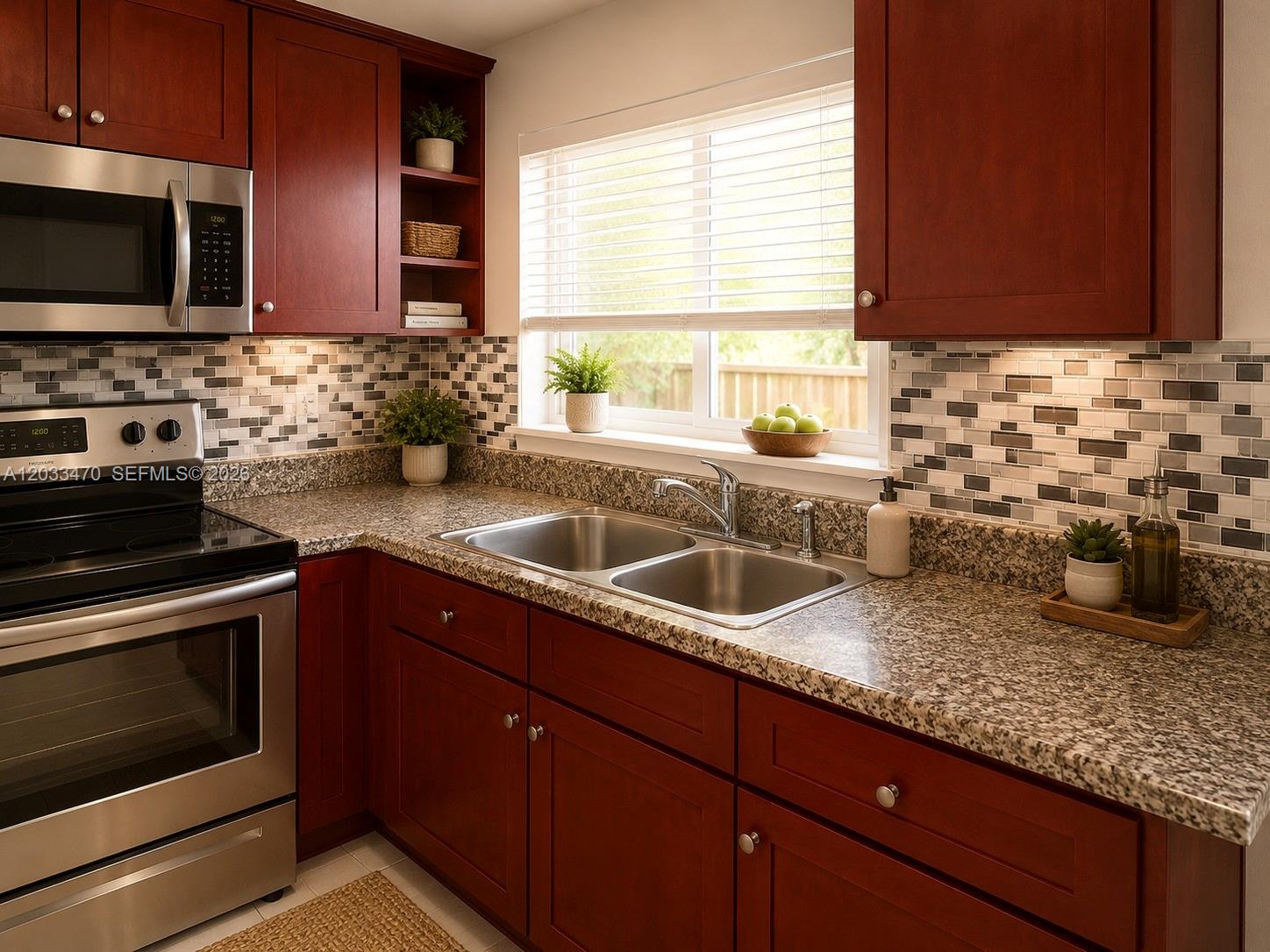 A kitchen features cherry wood cabinets, granite countertops, a stainless steel sink, and mosaic tile backsplash — 5461 W 24th Ave # 18, Hialeah FL 33016, HIALEAH, FL