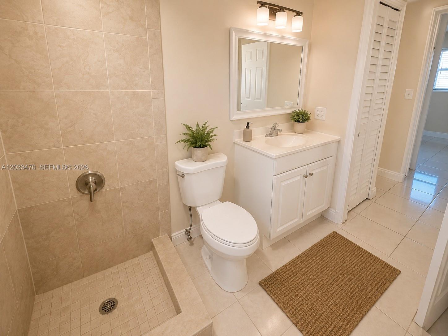 A bathroom features a tiled walk-in shower, a white vanity, and a toilet — 5461 W 24th Ave # 18, Hialeah FL 33016, HIALEAH, FL