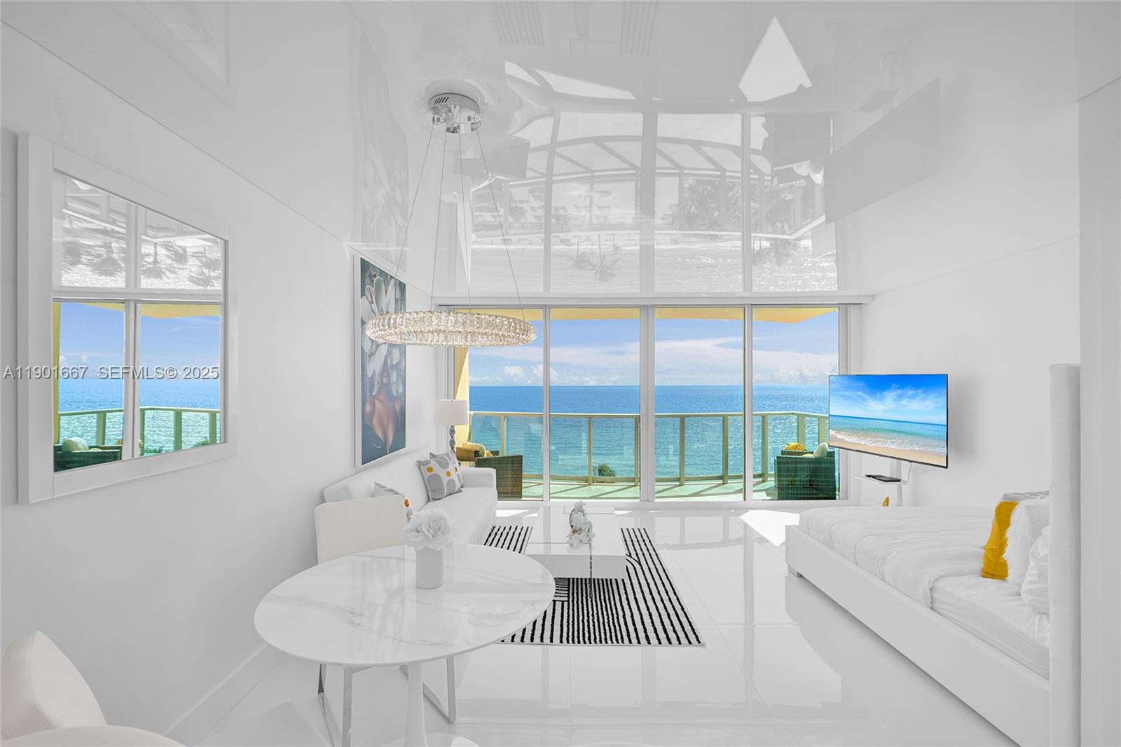 A bright, white-themed living room features floor-to-ceiling windows with an expansive ocean view — 2501 S Ocean Dr, Hollywood FL 33019, HOLLYWOOD, FL