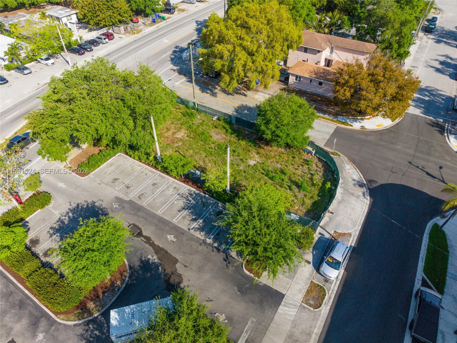 An aerial view shows a vacant, fenced-in lot adjacent to a paved parking area — 5434 NE Miami Ct, Miami FL 33137, MIAMI, FL