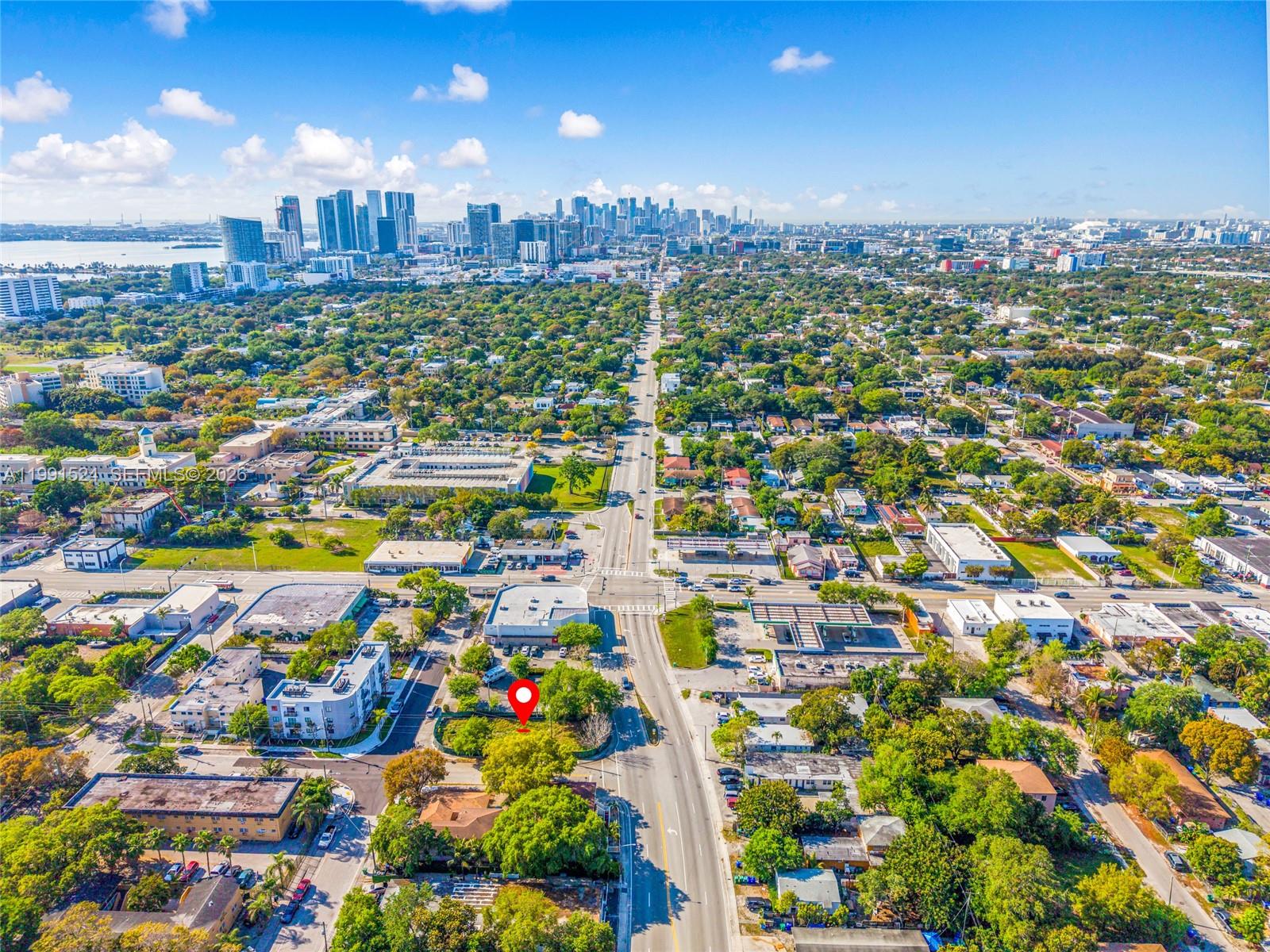 An aerial view shows a city skyline in the distance with a red map pin — 5434 NE Miami Ct, Miami FL 33137, MIAMI, FL