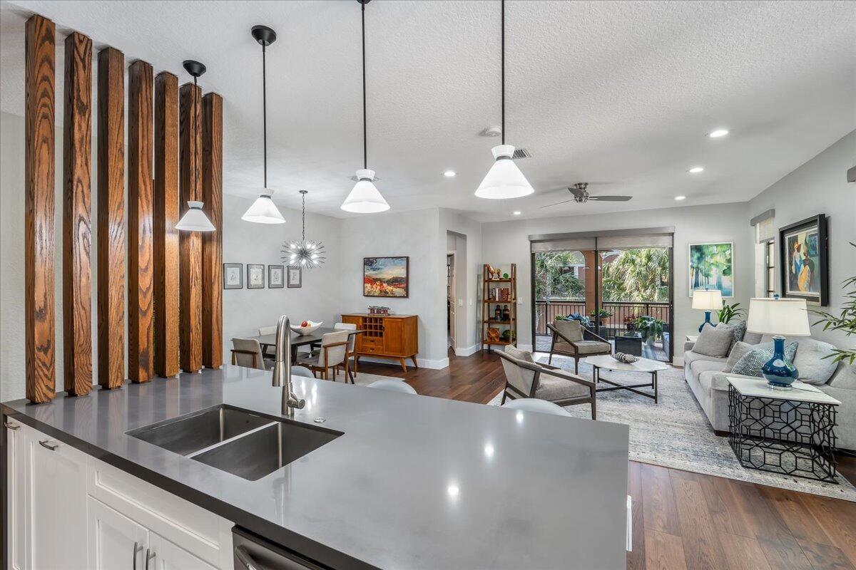 An open-concept kitchen, dining area, and living room featuring wood slat room dividers — 2802 Kinsington Circle # 4, Weston FL 33332, WESTON, FL
