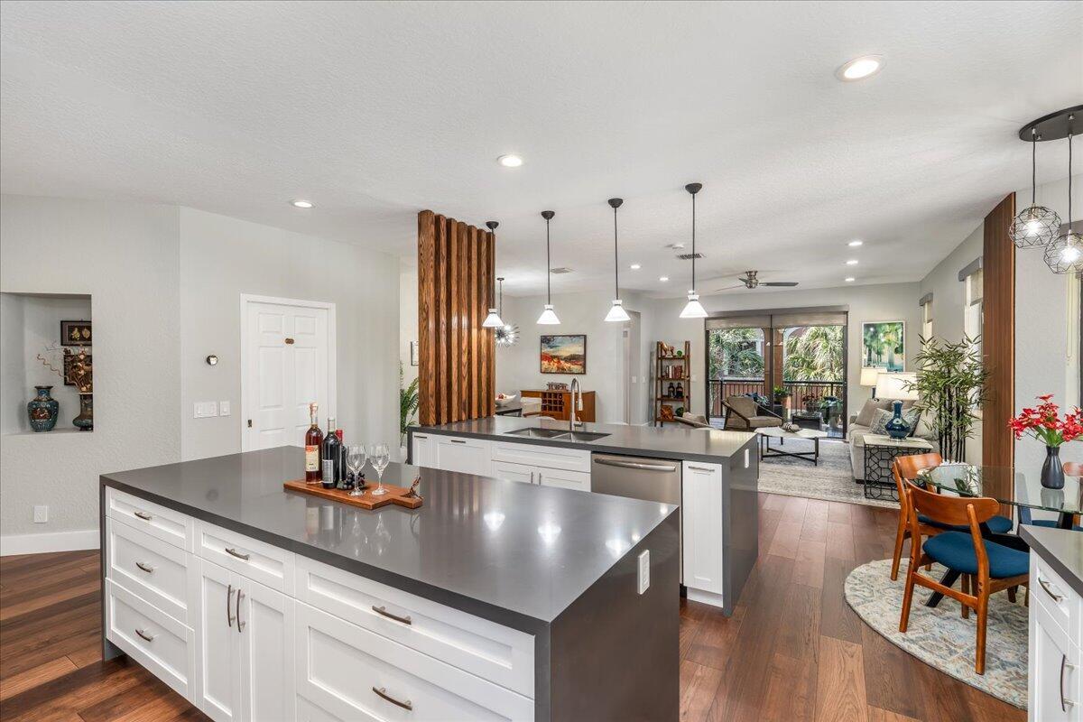 A modern kitchen features white cabinetry, dark gray countertops, and a wooden slat room divider — 2802 Kinsington Circle # 4, Weston FL 33332, WESTON, FL