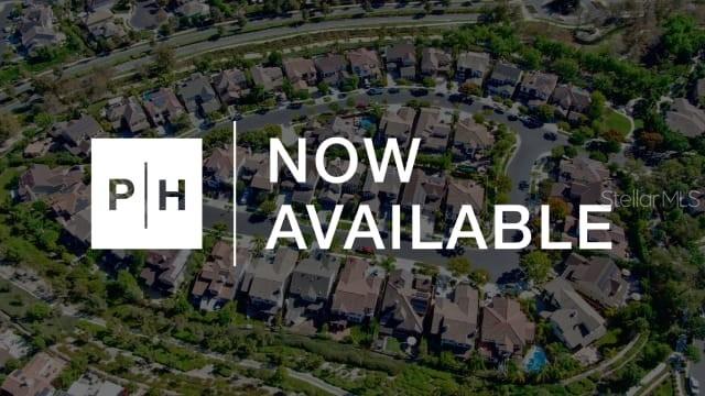 This is an aerial view of a suburban residential neighborhood with houses and winding streets — 9527 SANDY SHORES STREET, PARRISH, FL