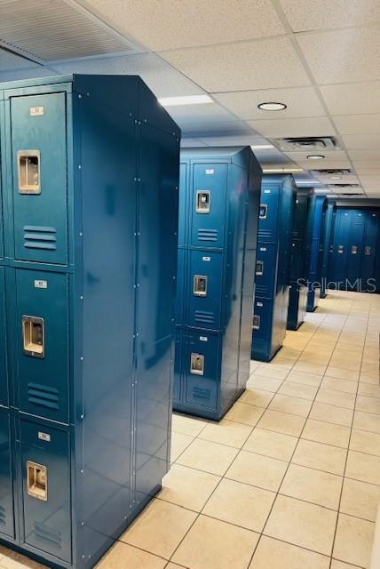 A row of blue metal lockers stands on a tiled floor in a locker room — 1780 PHILLIPPI SHORES DRIVE UNIT A3-22, SARASOTA, FL